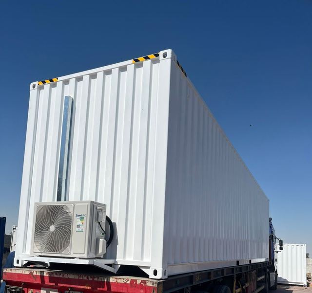 Refurbished portable cabin loaded on a truck for delivery to a project site in Saudi Arabia